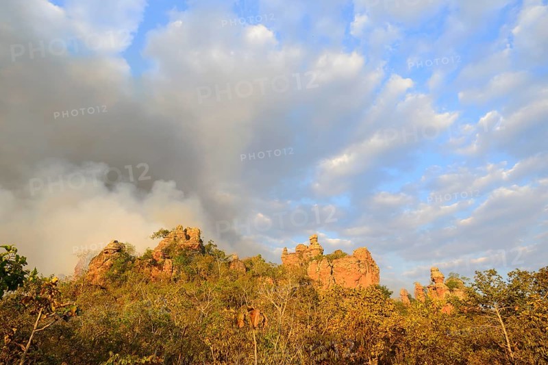 Bizarre rock formation and clouds of smoke during a bushfire