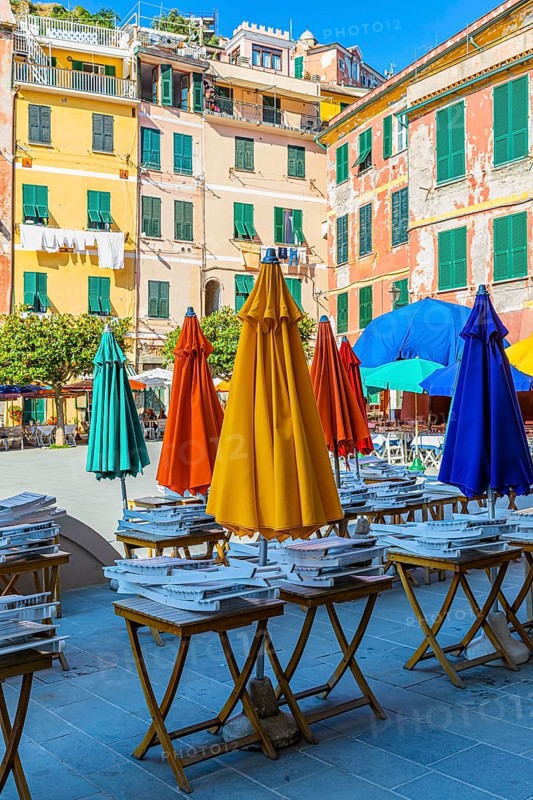 Coloured parasols of a closed restaurant at the main square of Vernazza