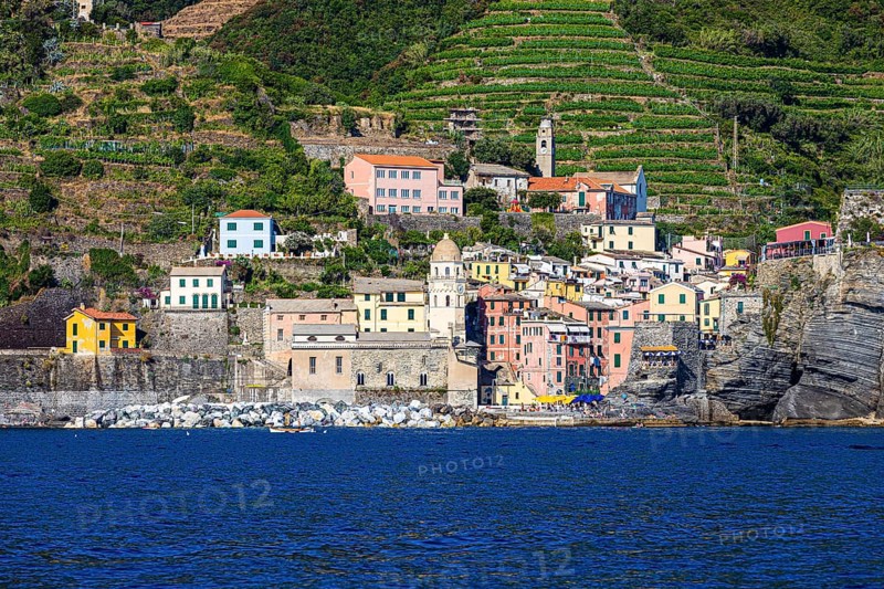 The village of Vernazza with its churches and pastel-coloured houses built into the hillside