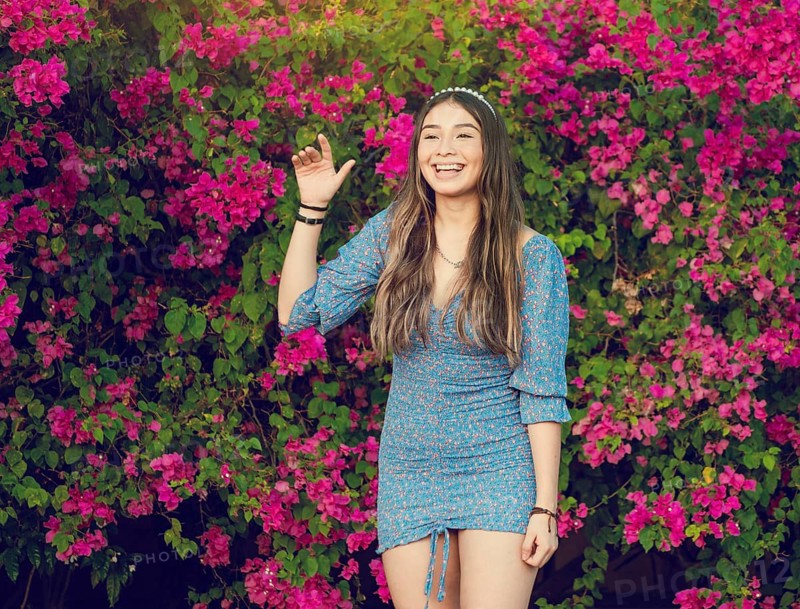 Portrait of a cute latin american girl smiling in a garden