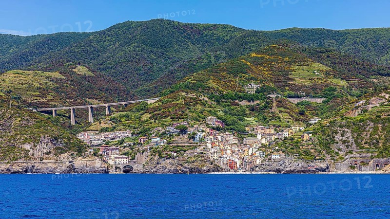 The village of Riomaggiore with its nested pastel-coloured houses built into the hillside