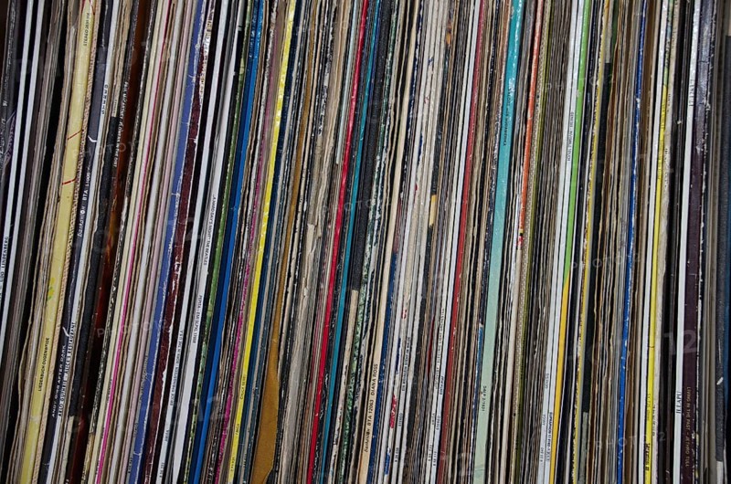 Old long-playing records stand on a shelf