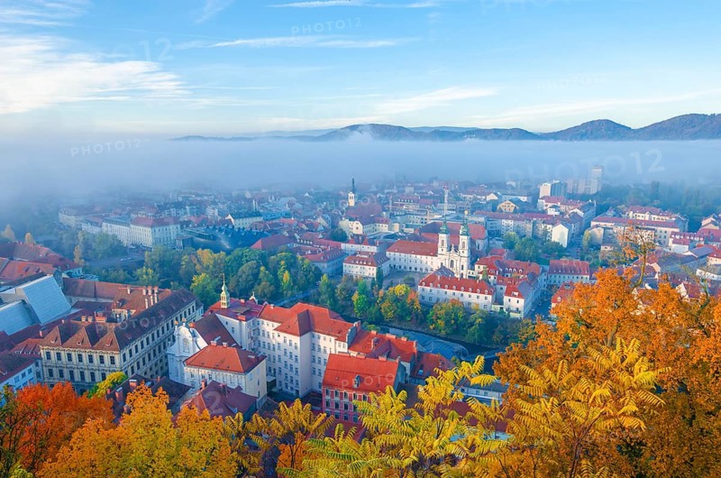 Cityscape of Graz with Mur river and Mariahilfer church