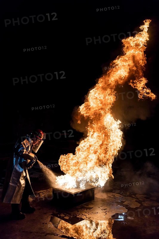 Firefighter extinguishes a heptane 2B-Pan fire with a 2-BTP extinguisher