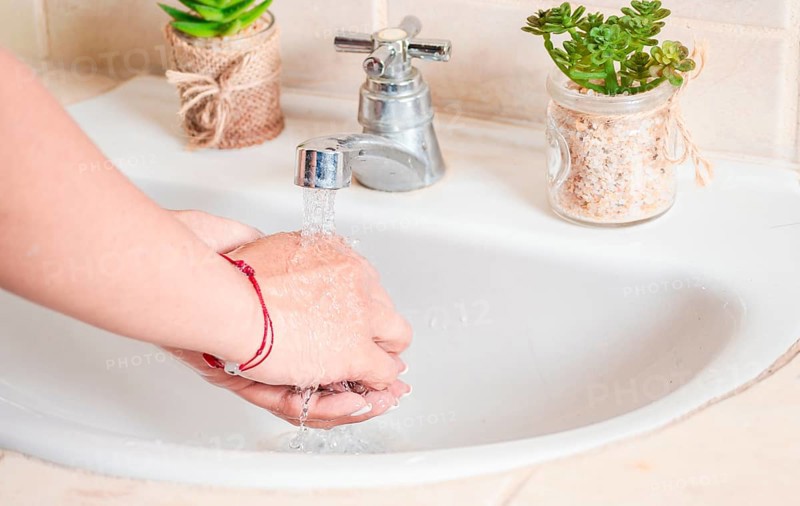 Close up of a person washing their hands with soap