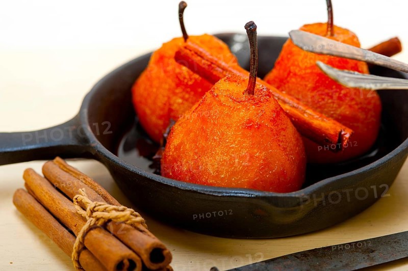 Poached pears delicious home made recipe ove white rustic wood table