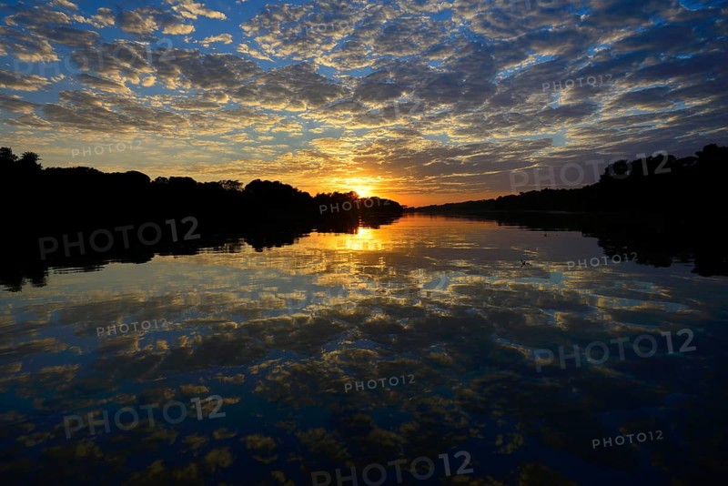 Sunrise with clouds reflected in Rio Sao Lourenco
