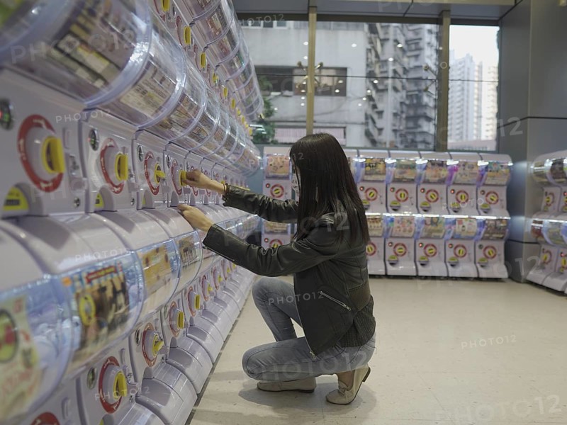 Girl at toy vending machine in Macau