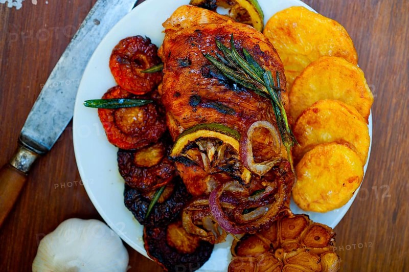 Roasted grilled BBQ chicken breast with herbs and spices rustic style