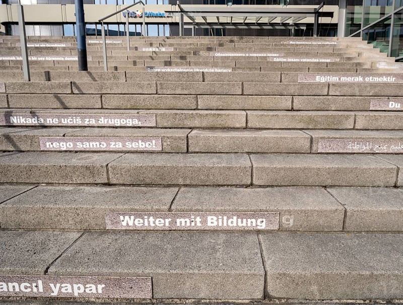 Stairway steps with slogans on the subject of education in several languages