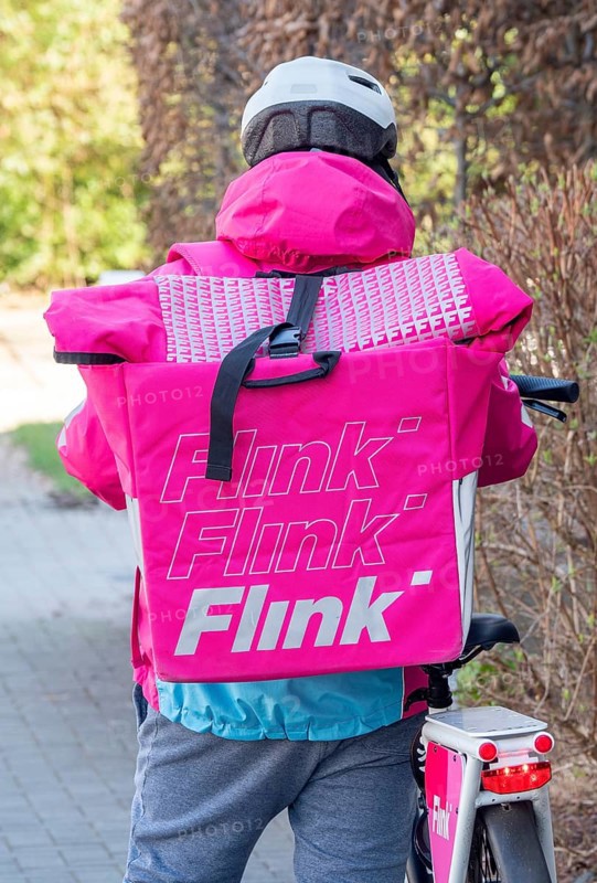 Delivery driver from the delivery service Flink with bicycle