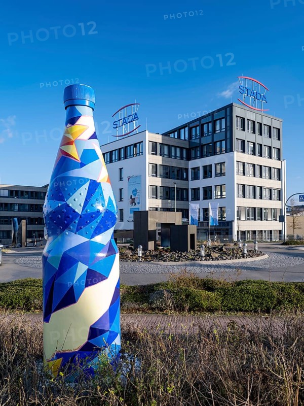 Building of the pharmaceutical company Stada Arzneimittel AG behind an oversized mineral water bottle