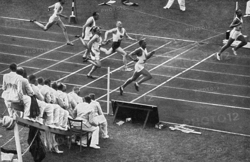 Jesse Owens tears the finish tape in the 100 m