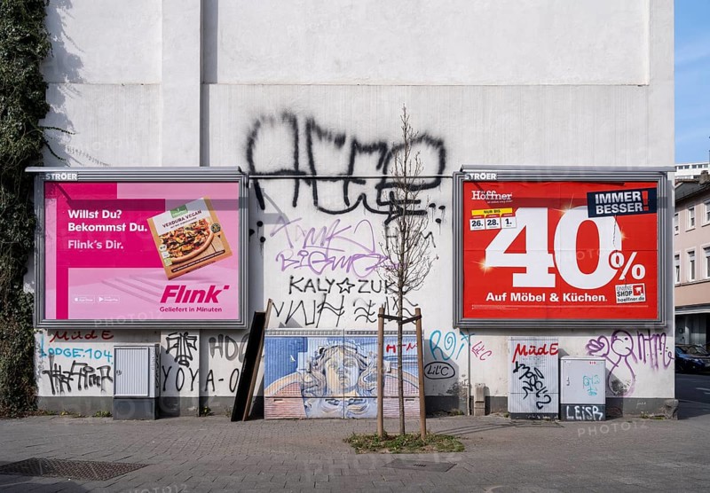 Large advertising posters for the delivery service Flink and Moebel Hoefner on a house wall