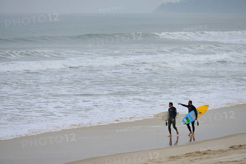 Two surfers with surfboard on Praia de Mocambique