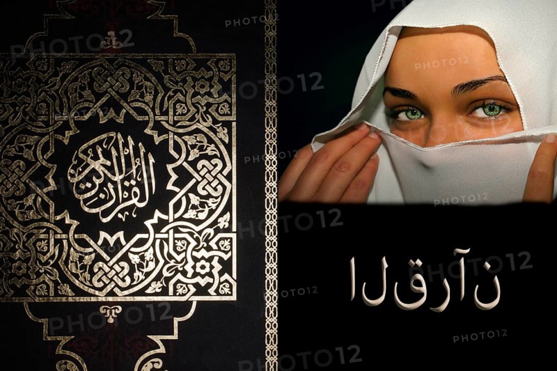 The holy book Koran with Arabic script and young woman with white niqab