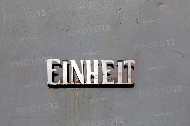 Unit lettering made of metal on a metal surface