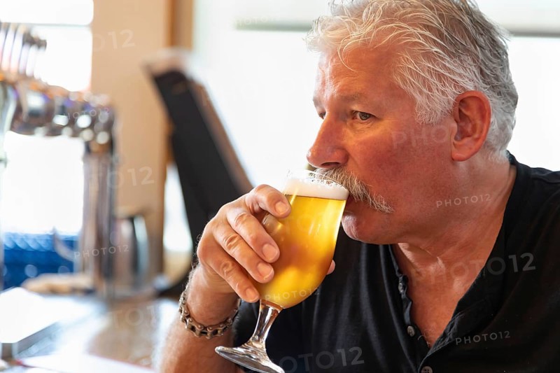 Handsome man tasting A glass of micro brew beer