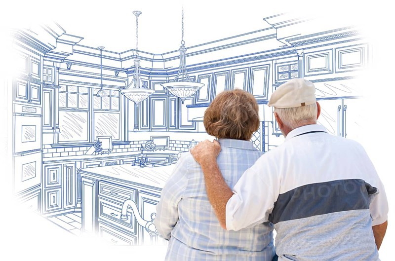 Curious senior couple looking over blue custom kitchen design drawing