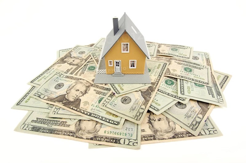 Home and money isolated on a white background