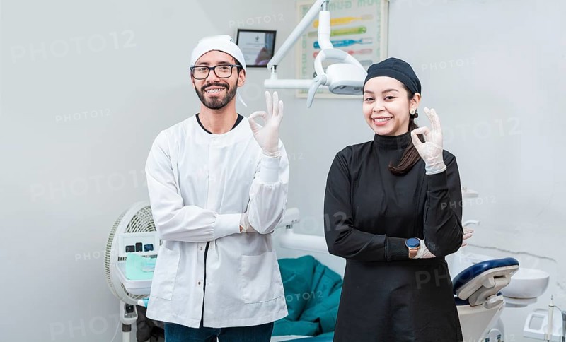 Portrait of dentist and her assistant in the office