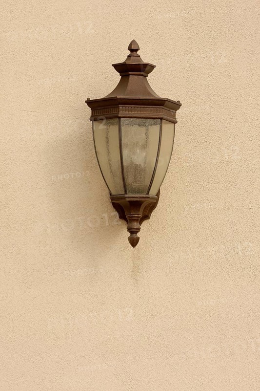 Beautiful lamp on stucco wall