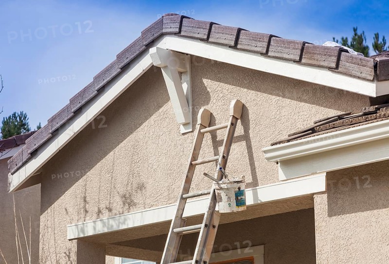 Construction ladder leaning up against A house ready for new paint