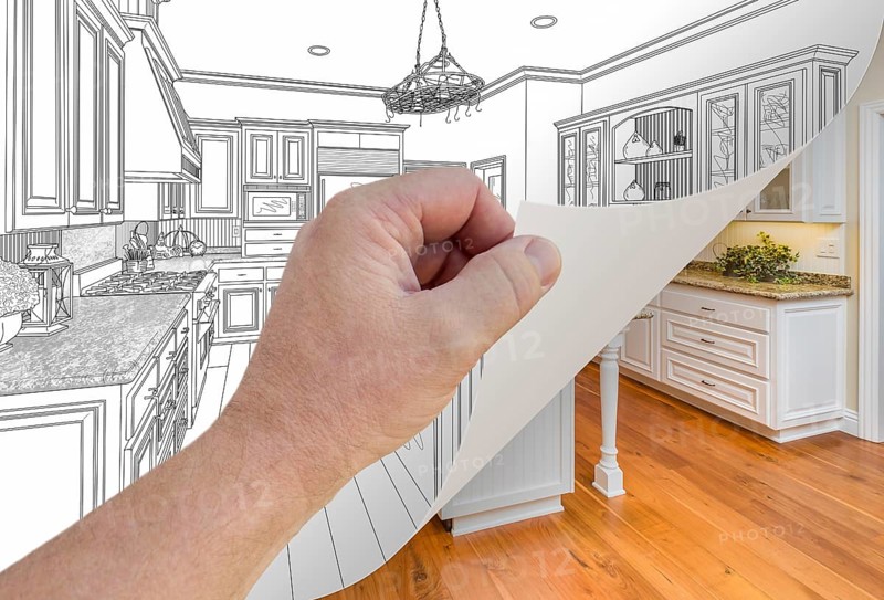 Male hand turning page of custom kitchen drawing to finished photograph underneath