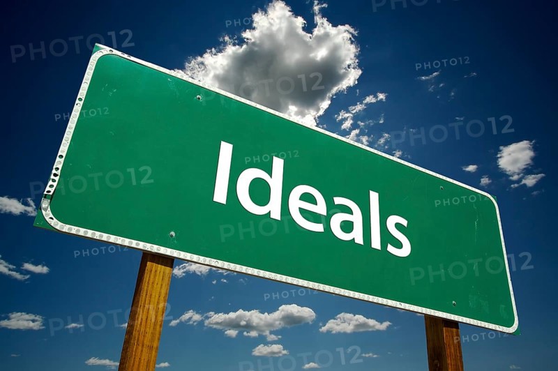 Ideals green road sign with dramatic clouds and sky