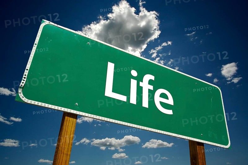 Life road sign with dramatic clouds and sky