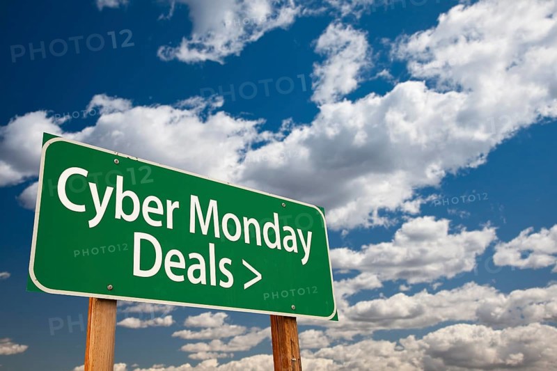 Cyber monday deals green road sign with dramatic clouds and sky