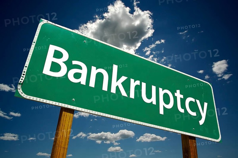 Bankruptcy road sign with dramatic clouds and sky
