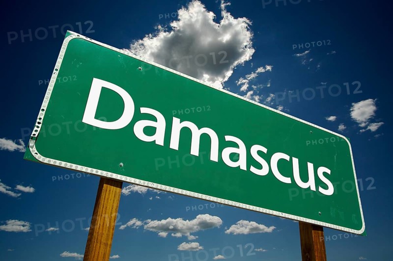 Damascus green road sign with dramatic clouds and sky