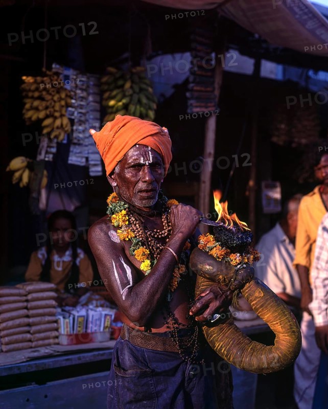 A devotee holding fire torch