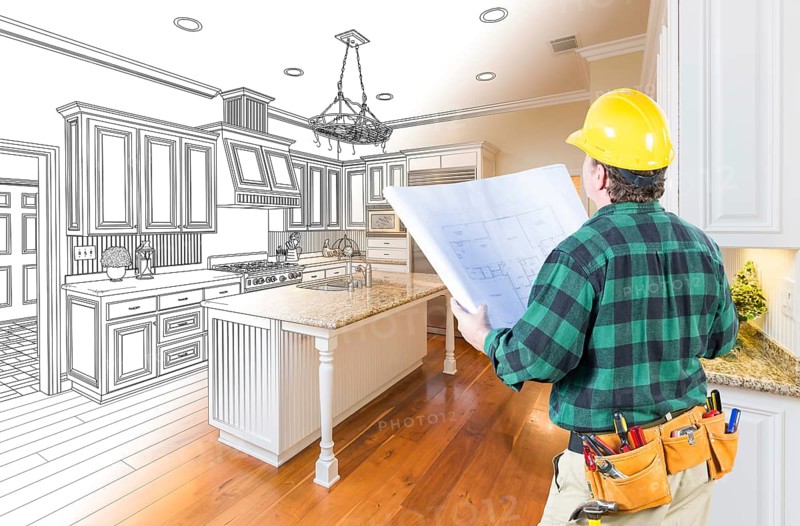 Male contractor with hard hat and plans looking at custom kitchen drawing photo combination on white