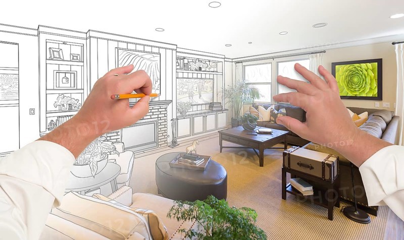 Male hands drawing custom living room design gradating into photograph