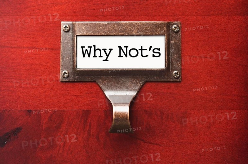 Lustrous wooden cabinet with why not's file label in dramatic light