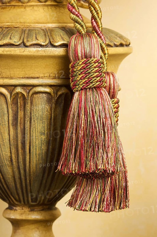 Lamp on table with ornate hanging tassel