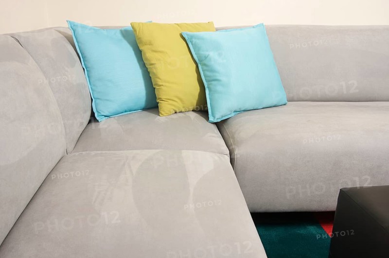 Abstract of grey suede couch & pillows
