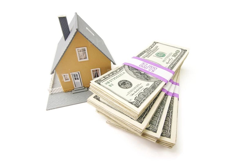 Home and stacks of money isolated on a white background