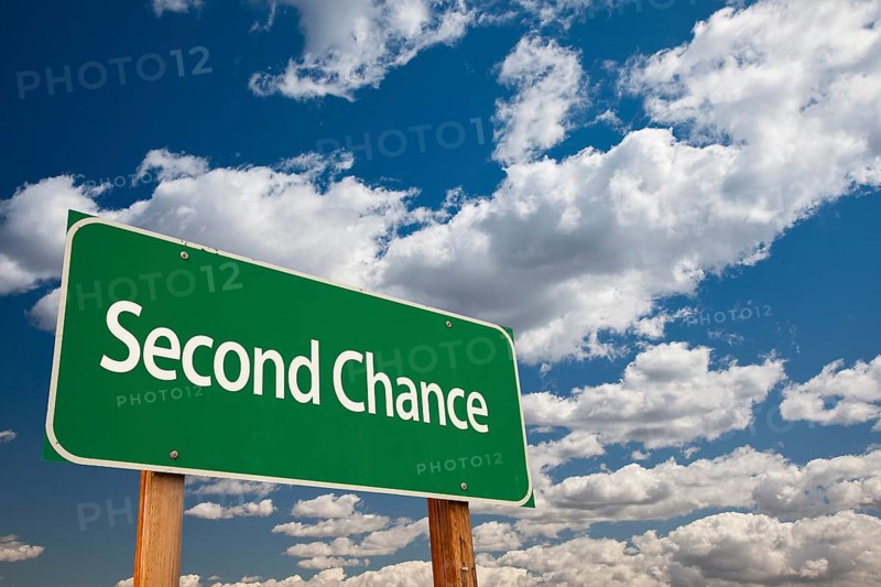 Second chance green road sign and dramatic clouds background