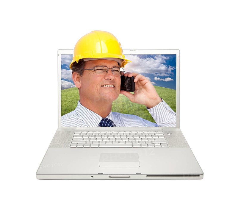 Laptop and man with hard hat on cell phone extruding the screen