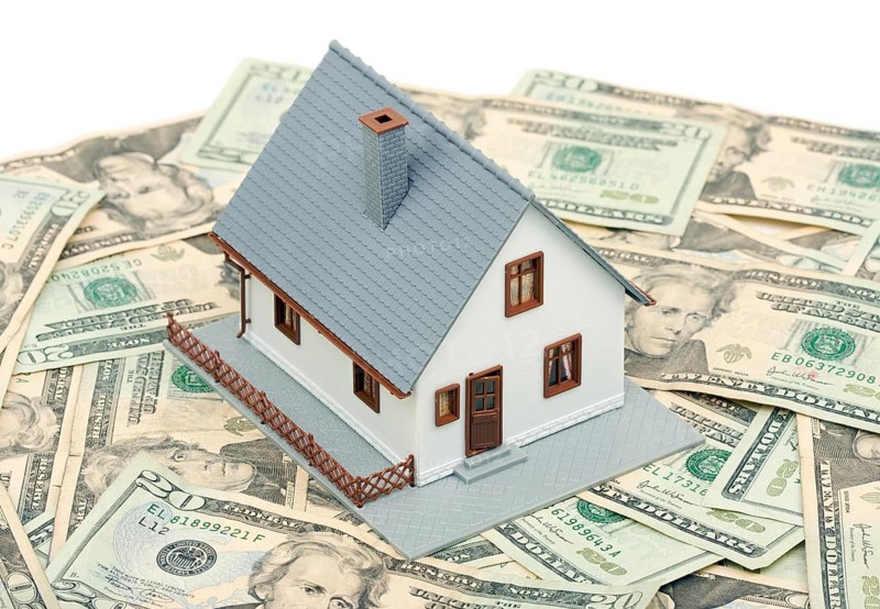 Home and money isolated on a white background