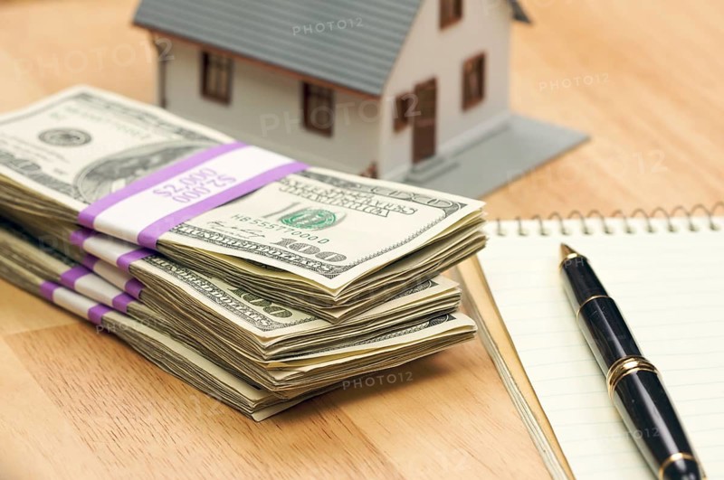 House and money with pad of paper and pen
