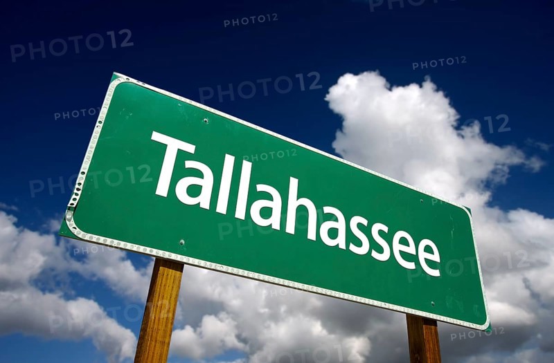 Tallahassee road sign with dramatic blue sky and clouds