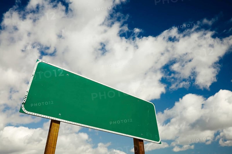 Blank road sign with dramatic clouds and sky ready for your own copy