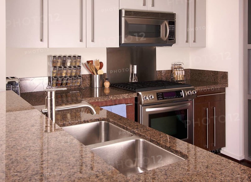 Modern apartment kitchen with brushed aluminum appliances
