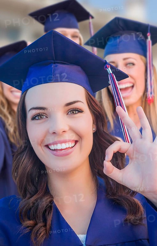 Happy graduating group of girls in cap and gown celebrating on campus