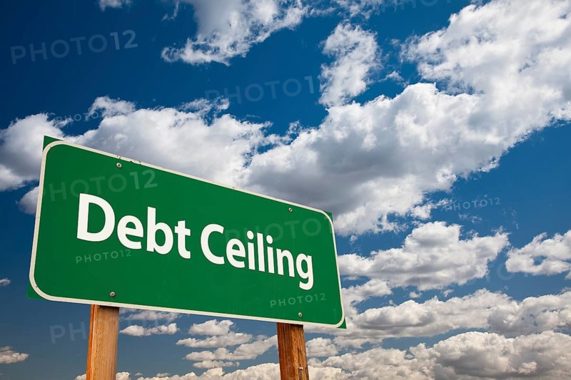 Debt ceiling green road sign over clouds and sky