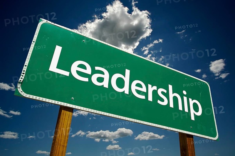 Leadership road sign with dramatic clouds and sky